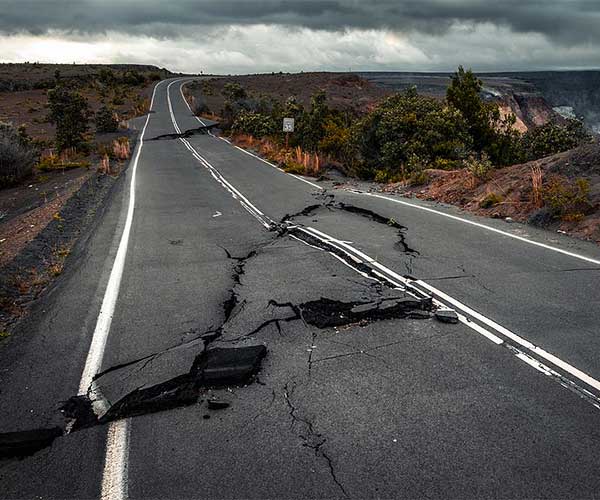 Damaged asphalt road in the Hawaii Volcanoes National Park after earthquake and eruption of Kilauea Volcano