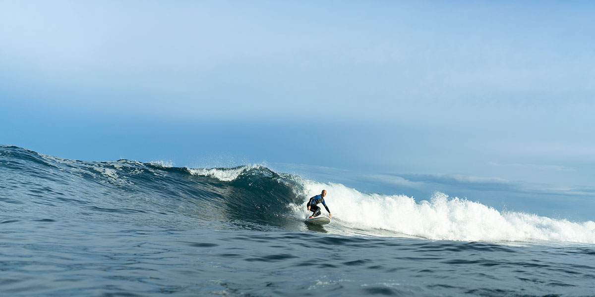 A person riding a barrel wave - plan your Big Island surfing today!