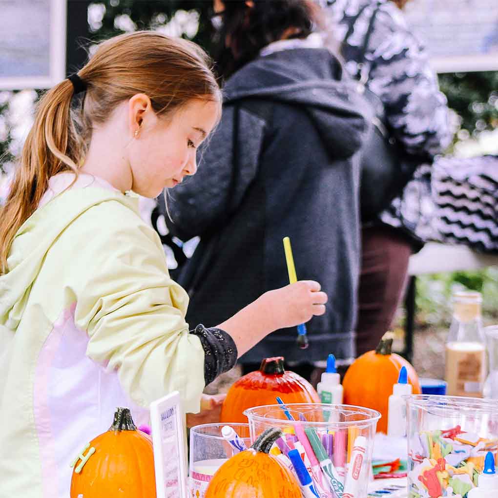 Young Girl painting a pumpkin