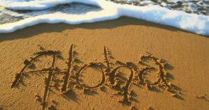 aloha written on the sand