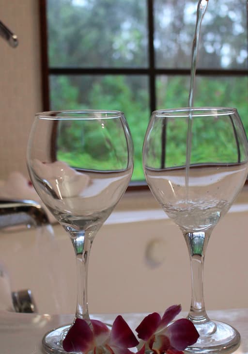 Two wine glasses on the edge of the tub at our Big Island bed and breakfast
