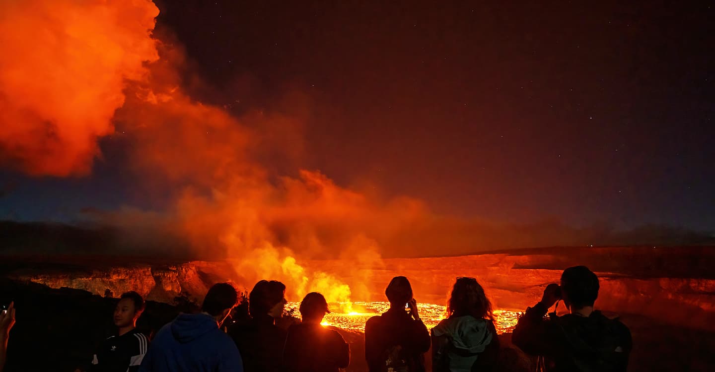 Visitors watching the glow of the Kilauea eruption at Hawaii Volcanoes National Park